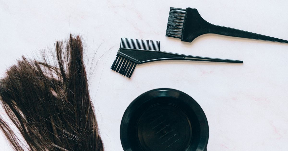 Colour tools beside strands of hair, ready for a strand test