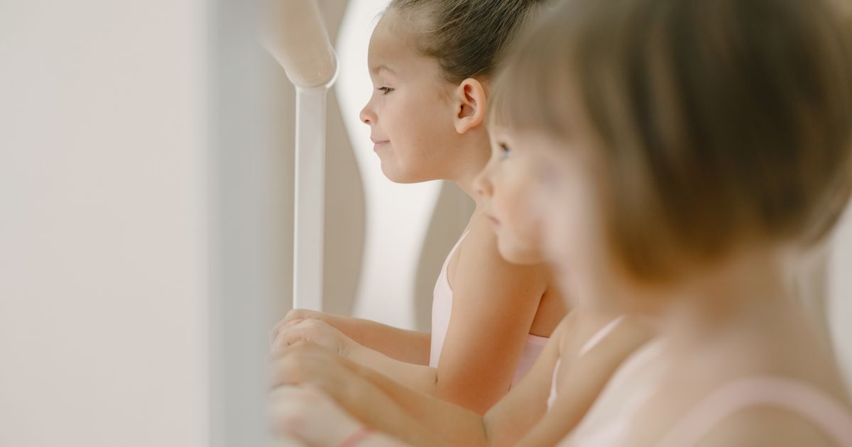 A children's ballet class at the barre, the class next door to a rented room