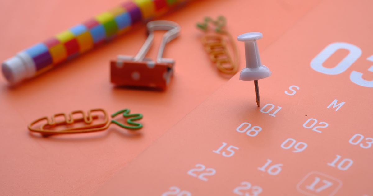 A white push pin in the first day of the month on a calendar
