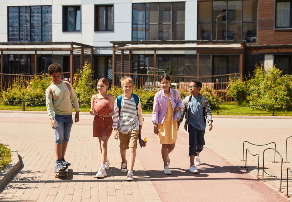 A group of children walking outside together