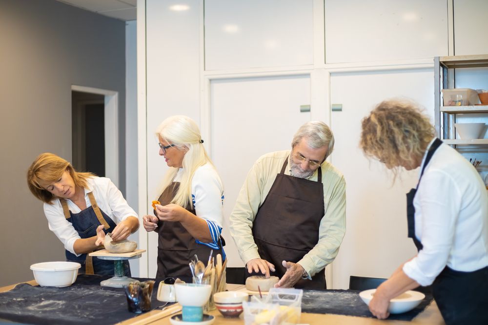 Adults at a pottery workshop