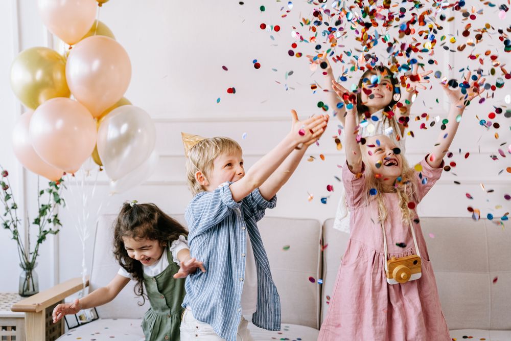 Kids throwing confetti at a birthday party
