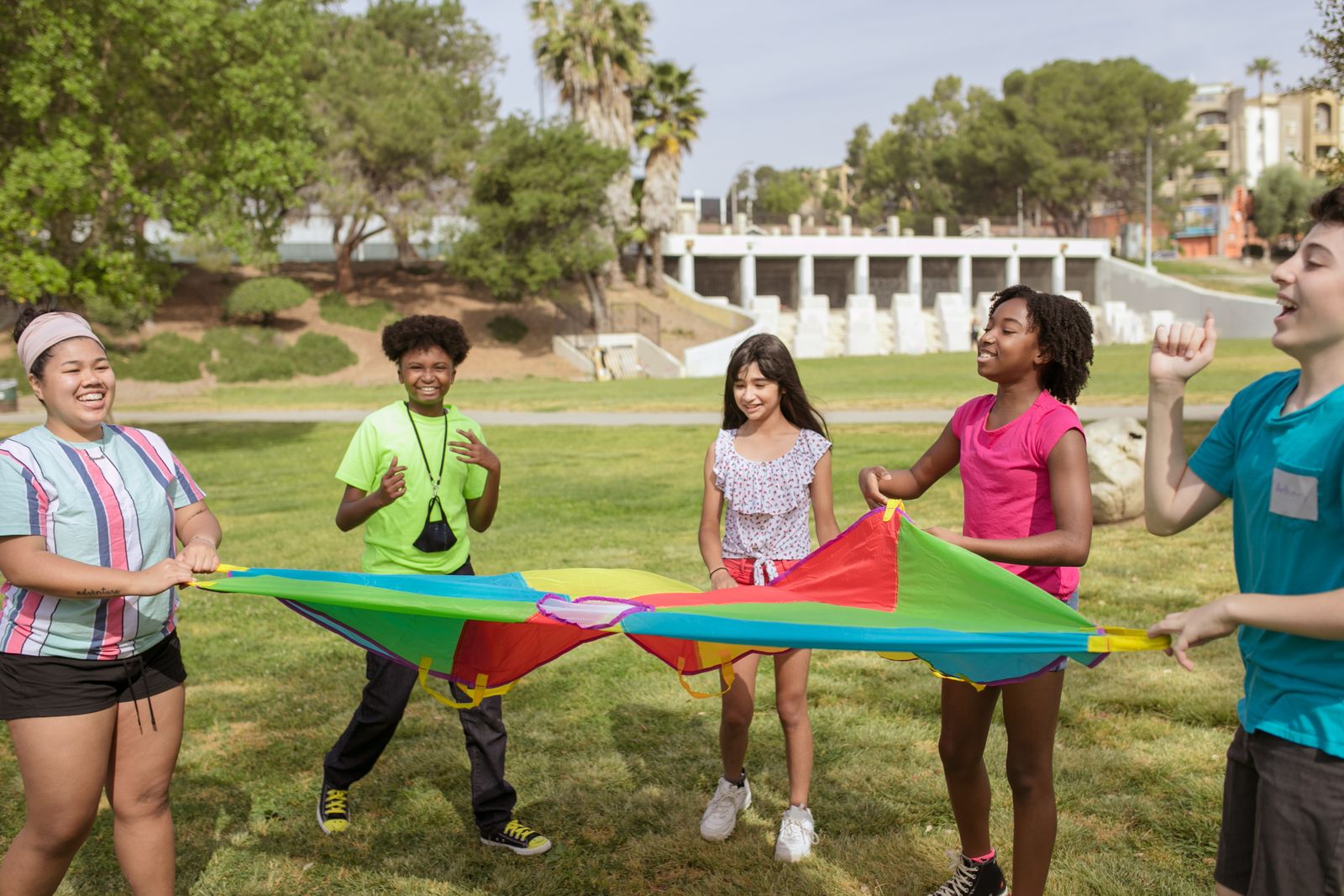 Campers playing a parachute game on the field