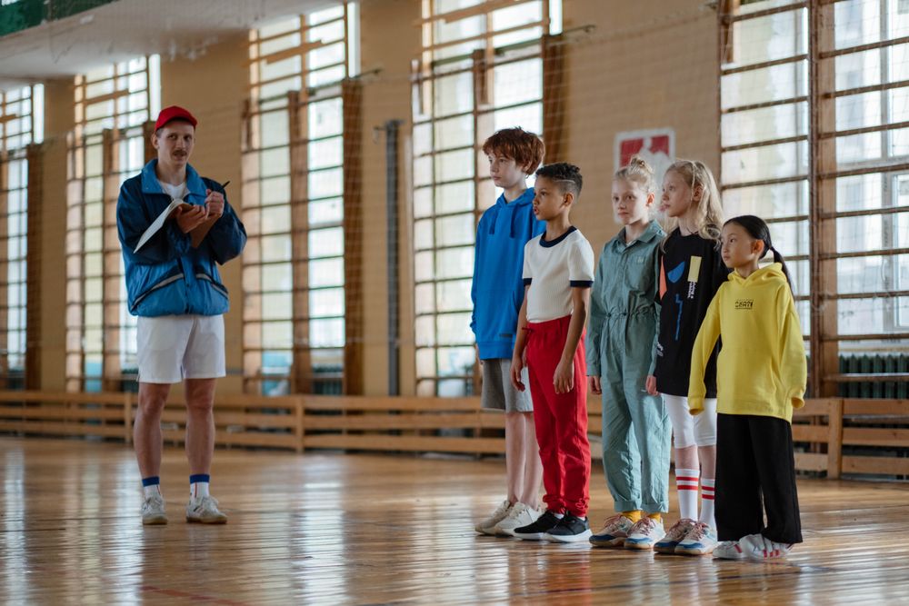 A coach with a children's gym class