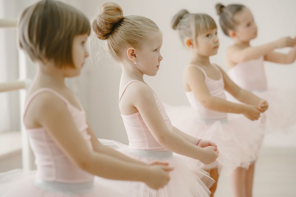 Preschool dancers in pink tutus at the barre