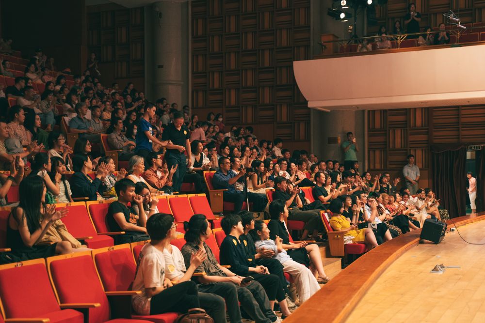 An audience applauding in a concert hall