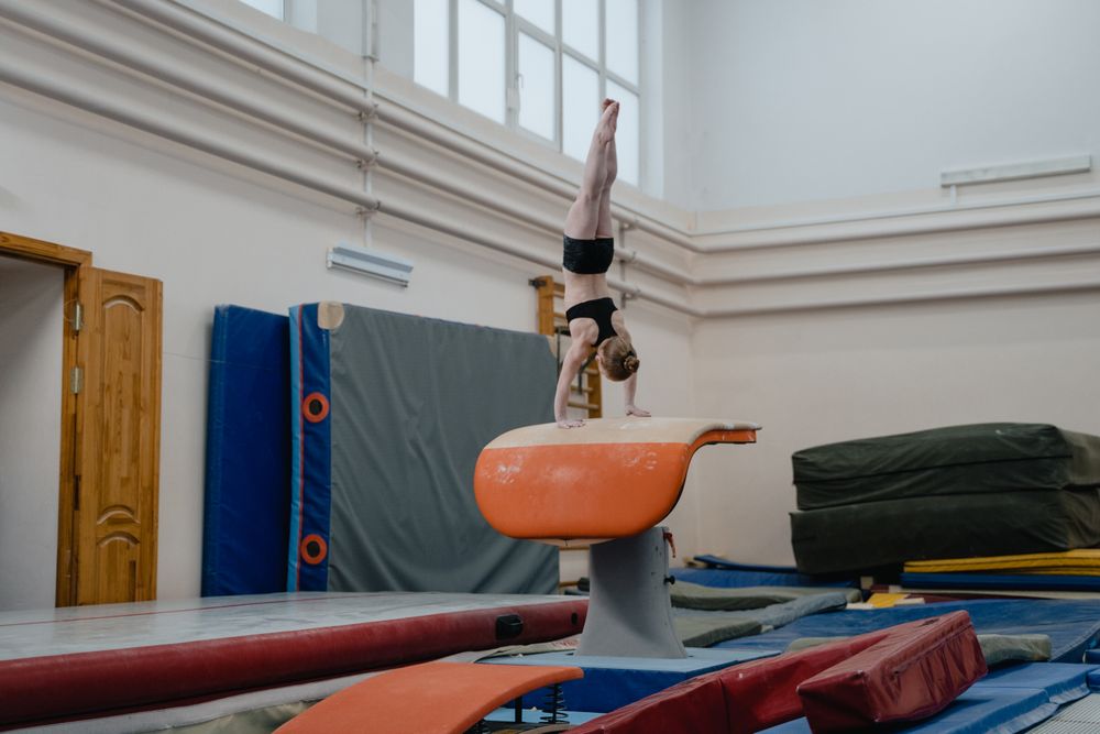 A gymnast in a handstand on the vault