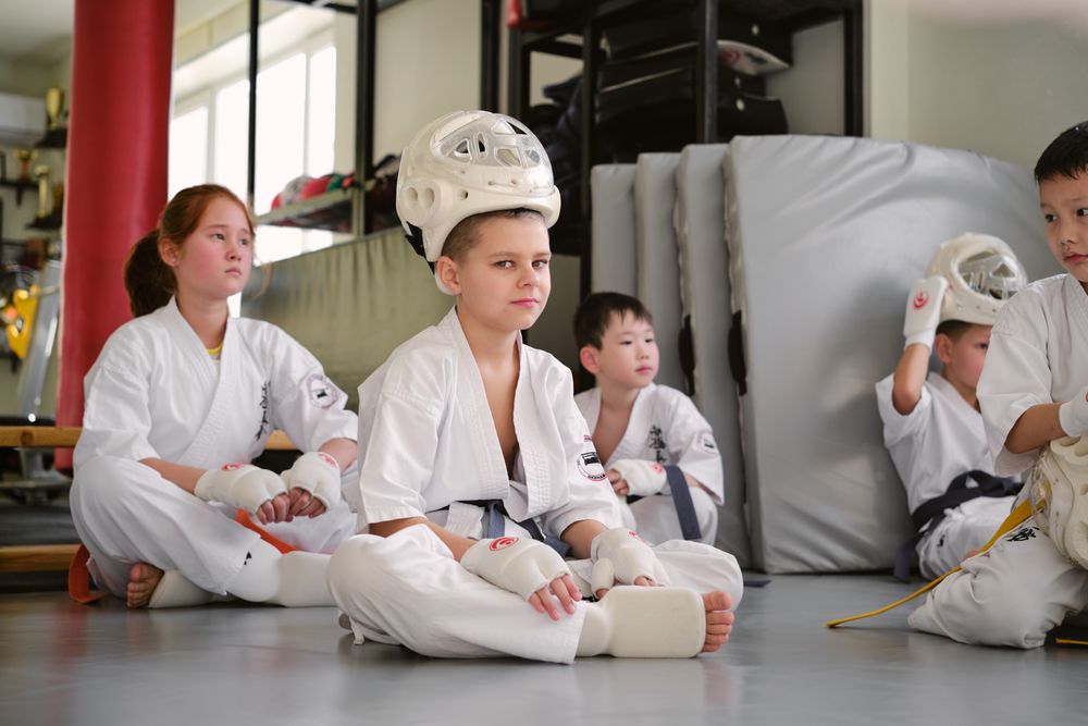 Kids in their sparring gear waiting for class