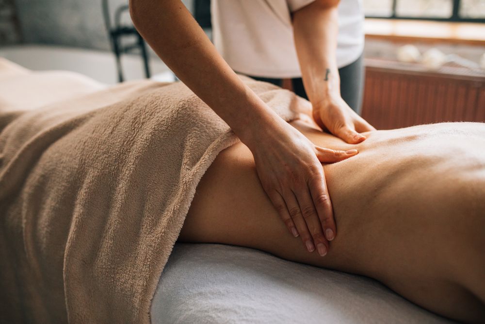 Hands working a client's back