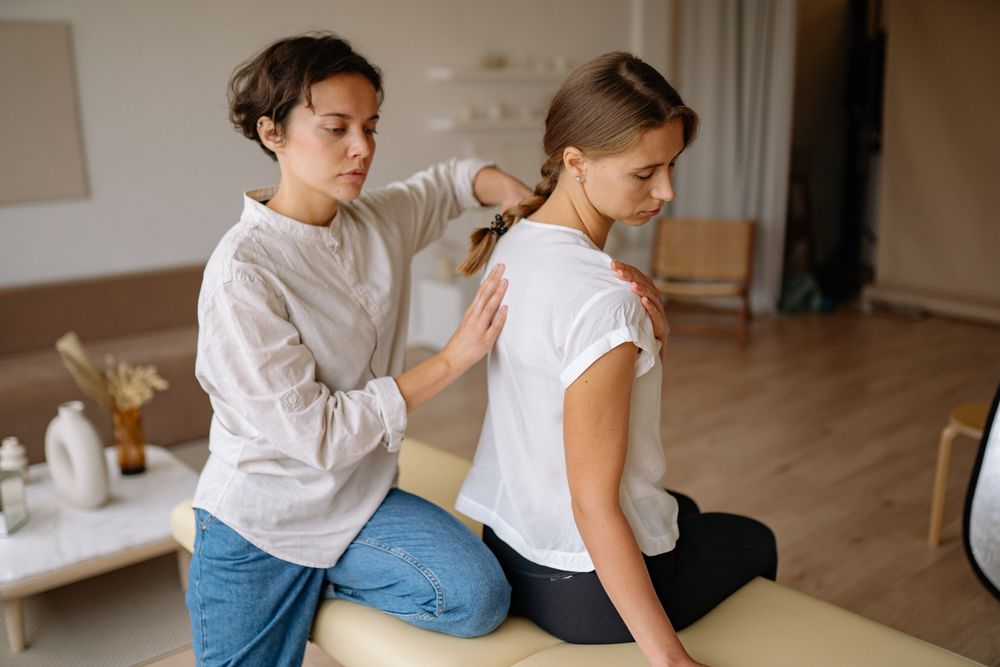 A therapist working on a client's shoulders