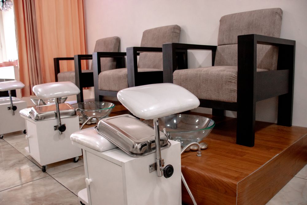 A row of pedicure chairs and basins