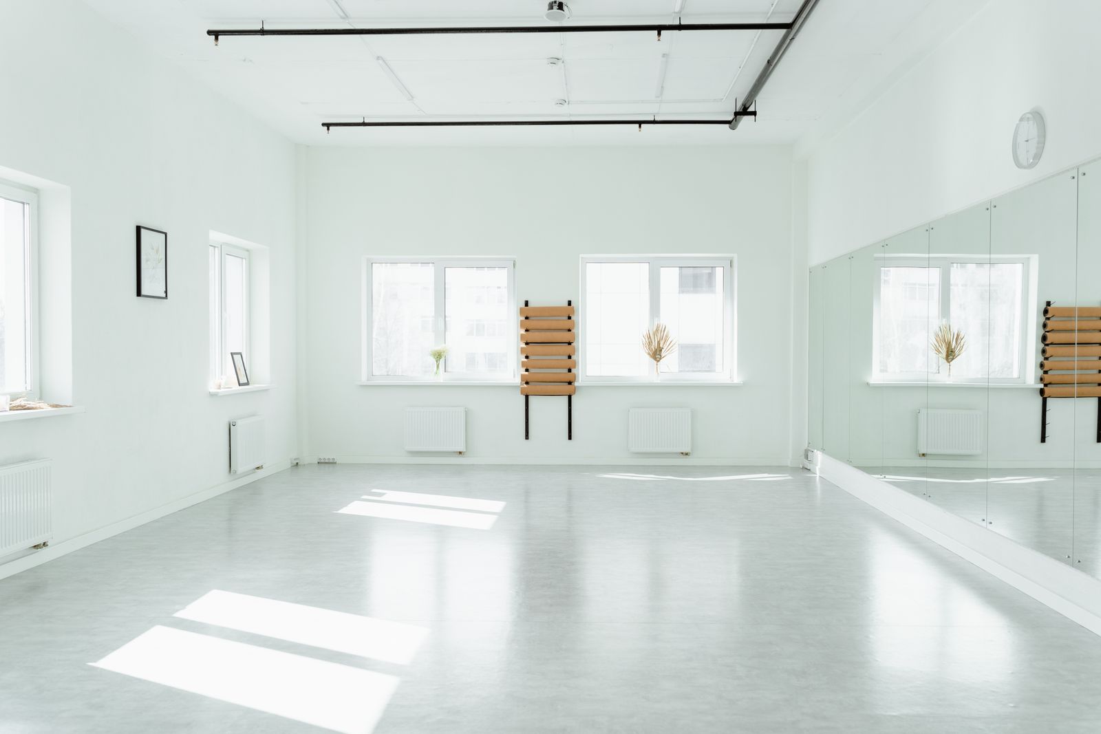 An empty, bright dance studio with mirrors