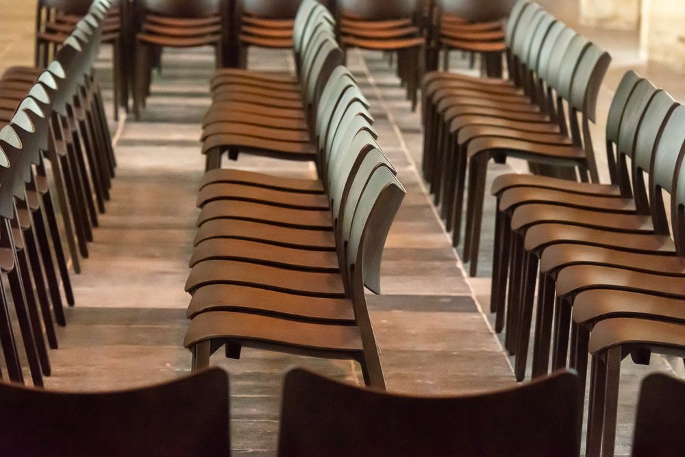 Rows of chairs set up in a hall