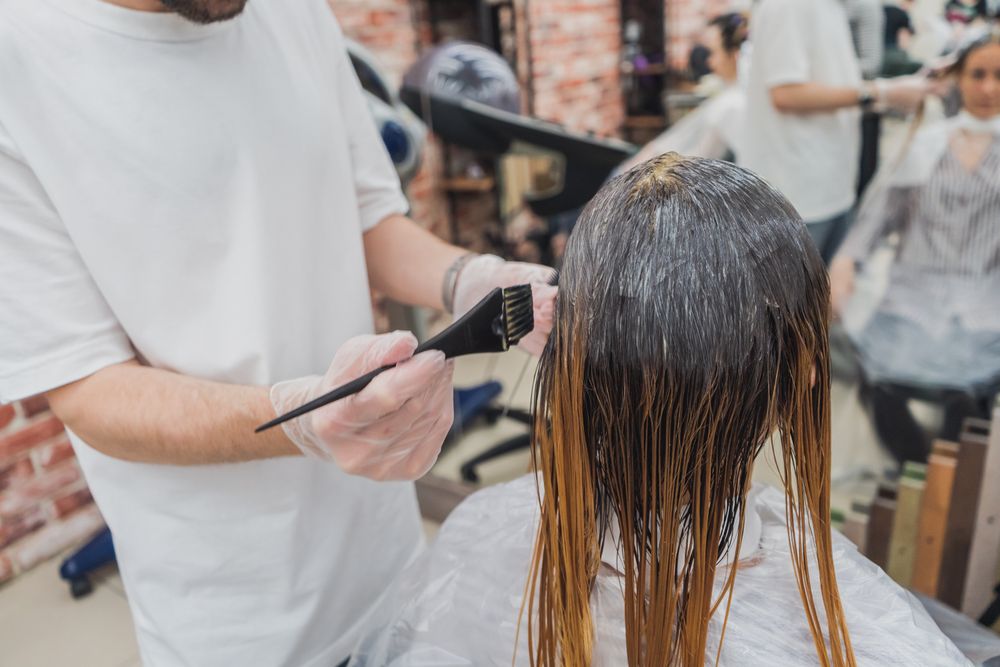 A stylist applying colour