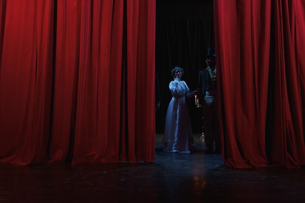 A performer waiting behind the curtain